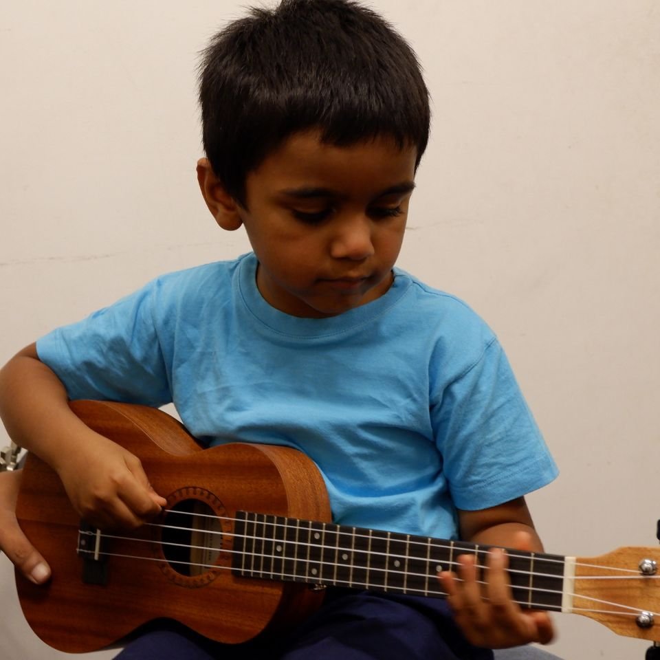 https://test.rainbowbridgeschool.com/wp-content/uploads/2025/01/900900-rb-student-ukulele.jpg